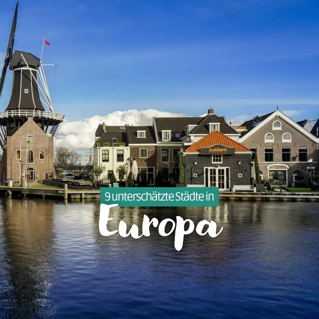 Häuser und eine Windmühle an einem Flussufer hinter dem Titel "9 unterschätzte Städte in Europa".