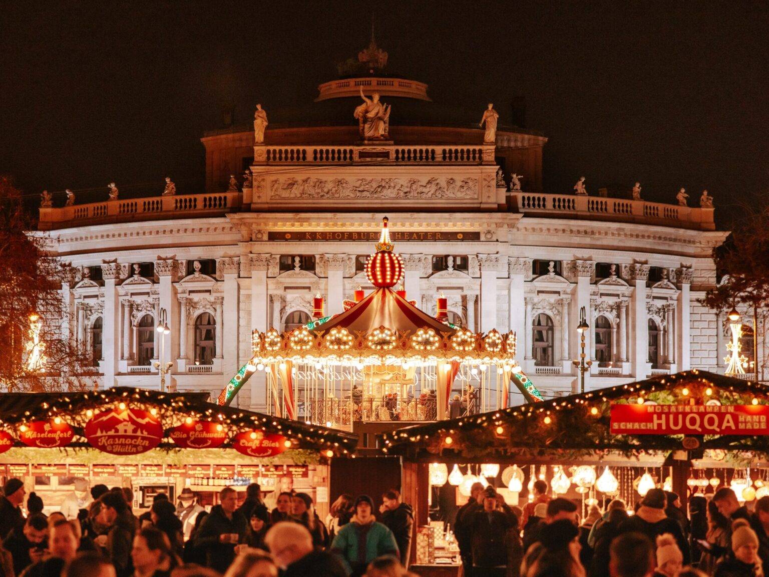 Weihnachtsmarkt-Stände und ein Karussell auf dem Platz vor dem Burgtheater in Wien.