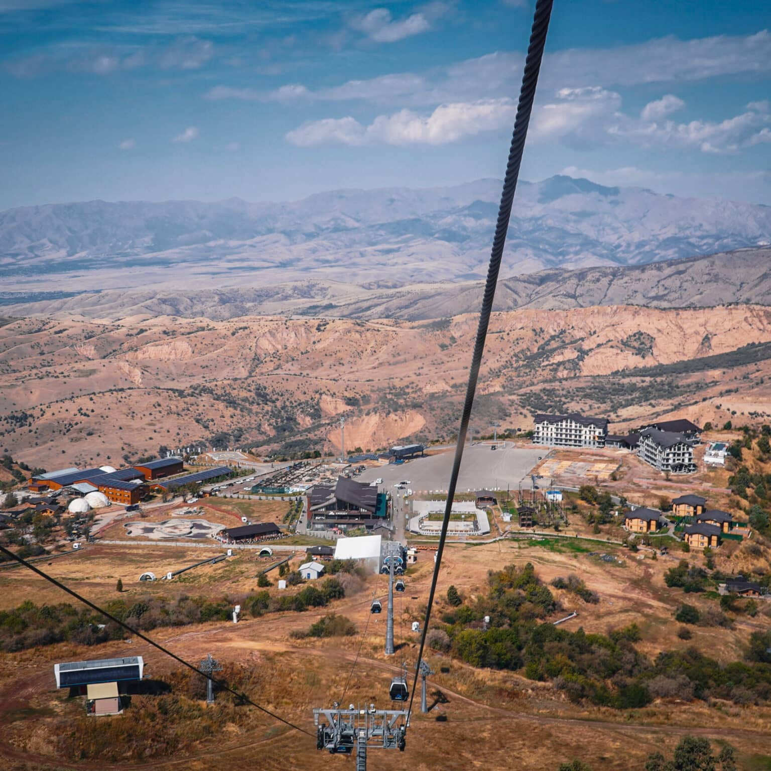 Blick auf die Berge und die Seilbahn aus einer Gondel in den Chimgan-Bergen in Usbekistan