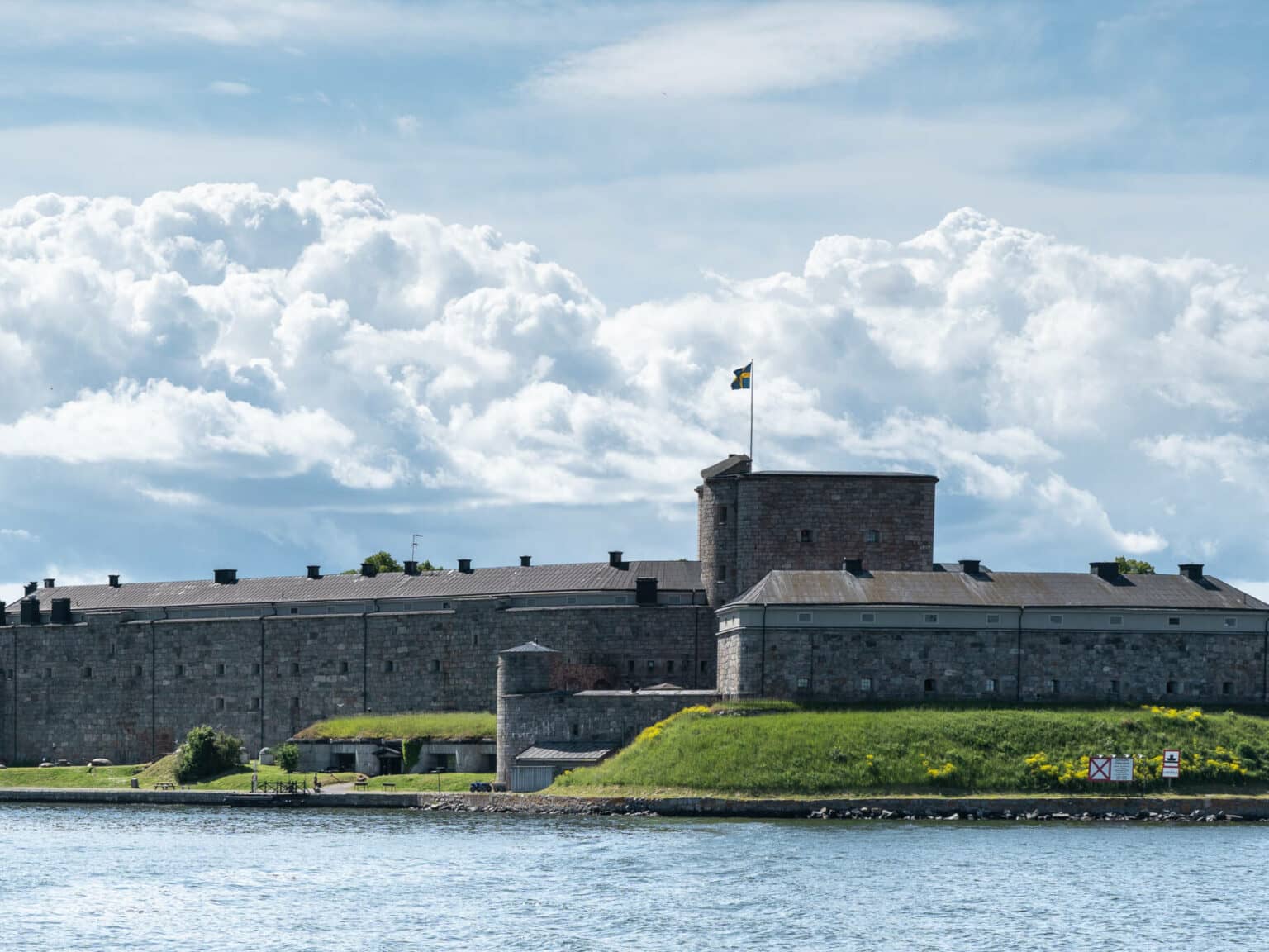 Von der Fähre aus kann man einen Blick auf das Kastell Vaxholm erhaschen, das auf einem sanften grünen Hügel gebaut wurde.