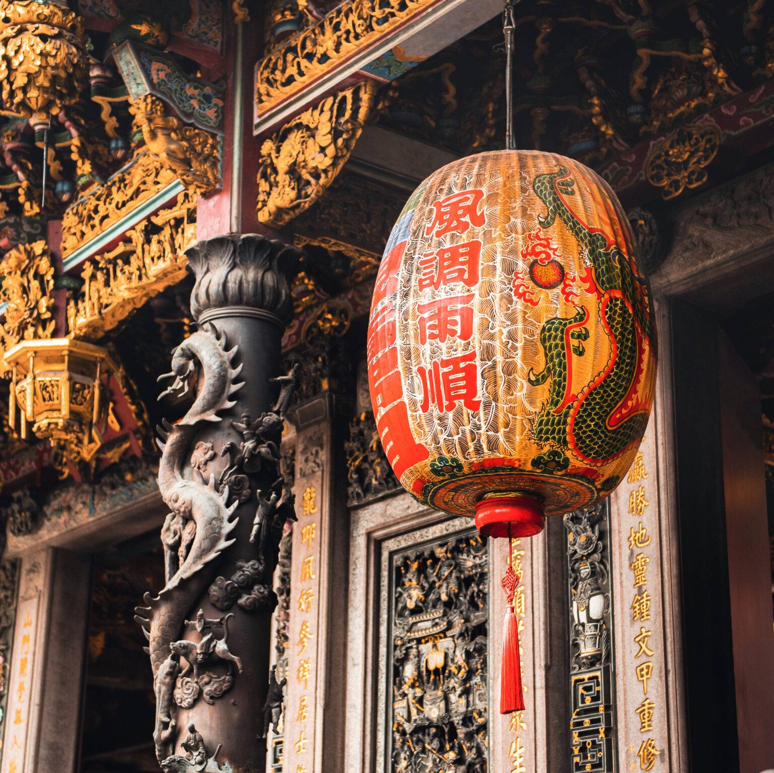 Prunkvolle Schnitzereien und ein Lampion im Longshan-Tempel in Taipeh.